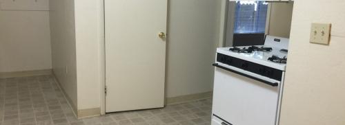 Kitchen shows a panty door and white range.