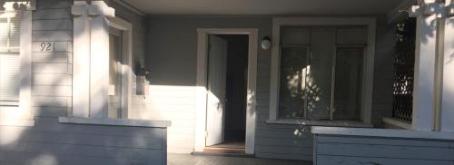 Front of the house shows a large porch with steps